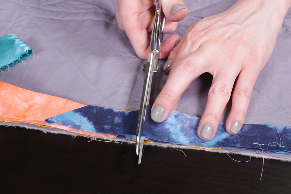 How to Make a Herringbone Quilt - Cut off extra binding